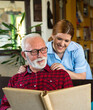 © Solid photos - Senior man with young nurse at home getting home care