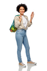 Wall Mural - sustainability, food shopping and eco friendly concept - happy smiling woman holding reusable string bag with fruits and vegetables over white background