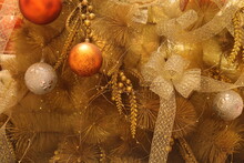 Golden Christmas Tree Pine Decorated With Gold Decorations And Bright Light Background