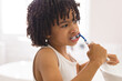 © WavebreakMediaMicro - Cute curly hair hispanic boy brushing teeth in bathroom at home
