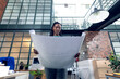 © Wavebreak Media - African american young female architect holding blueprint while standing in modern office
