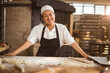 © Wavebreak Media - Portrait of smiling asian mid adult female baker standing in bakery