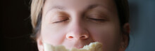 Woman Sniffing Delicious Fragrant Piece Of White Bread