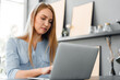 © fotofabrika - Young female entrepreneur working on a laptop at home