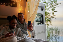 Young Couple Taking Selfie In Camper Van