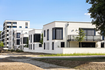 Modern Facade Apartments, Modern Exterior Residential Buildings with Blinds Windows. New Residential block of low-rise Buildings. Landscaping in residential area.