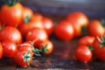 Wall Mural - Ecological fresh farm cherry tomatoes on a wooden background.