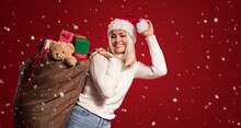 Beautiful Woman Carrying A Christmas Bag With Presents