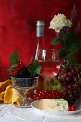 Canvas Print - Grapes, wine and cheese on a table. Colorful summer still life on textured background with copy space.