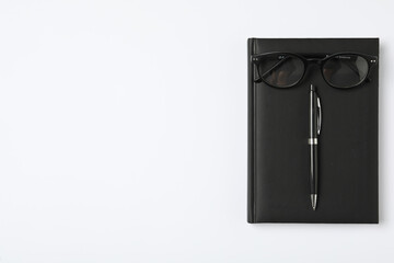 Canvas Print - Notebook, pen and eyeglasses on white background, flat lay with space for text. Teacher's Day