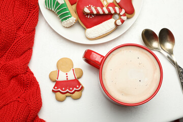 Wall Mural - Cup of hot coffee and cookies on white table, top view. Winter drink