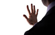 © Duncan Andison - A cutout of a businessman holding out his hand as if placing it on a screen to be scanned in a low light room. A design element for use with composite imagery