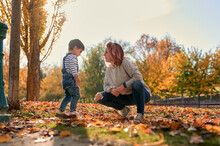Loving Mother And Kid In Autumn Park