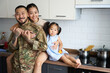 © Svitlana - Woman hugging her military husband and little daughter