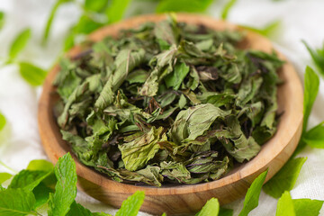 Wall Mural - Dried mint leafs on wooden surface. Herbs and spices.