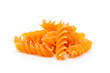 Pasta in a close up, orange colored, vegan, pasta, fusilli, noodle, white background, cropped image