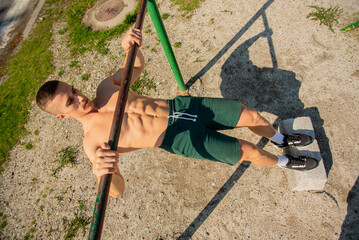 Wall Mural - Exercising topless on the training bar