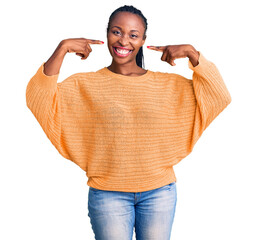 Canvas Print - Young african american woman wearing casual clothes smiling cheerful showing and pointing with fingers teeth and mouth. dental health concept.