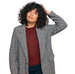 Poster - Young hispanic woman wearing business clothes confuse and wonder about question. uncertain with doubt, thinking with hand on head. pensive concept.