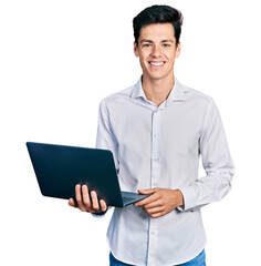 Young hispanic business man working using computer laptop looking positive and happy standing and smiling with a confident smile showing teeth