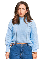 Wall Mural - Young brunette woman wearing casual winter sweater skeptic and nervous, frowning upset because of problem. negative person.