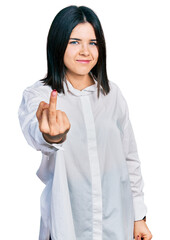 Poster - Young brunette woman with blue eyes wearing oversize white shirt showing middle finger, impolite and rude fuck off expression