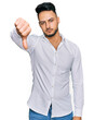 © Krakenimages.com - Young arab man wearing casual clothes looking unhappy and angry showing rejection and negative with thumbs down gesture. bad expression.