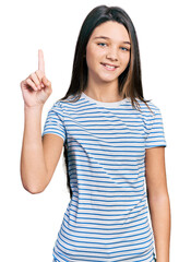 Sticker - Young brunette girl with long hair wearing casual striped t shirt smiling with an idea or question pointing finger up with happy face, number one