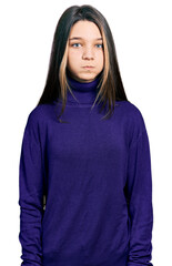 Sticker - Young brunette girl with long hair wearing turtleneck sweater puffing cheeks with funny face. mouth inflated with air, crazy expression.