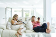 © ADDICTIVE STOCK - Couple sitting on sofa with animals and watching TV