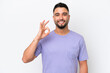 © luismolinero - Young Arab handsome man isolated on white background showing ok sign with fingers