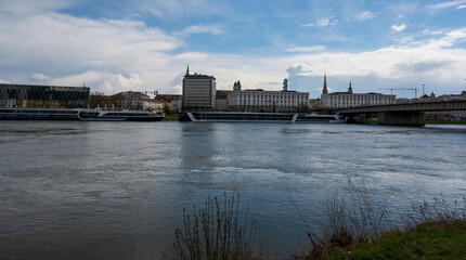 Wall Mural - Panorama of the city behind the river with boats.