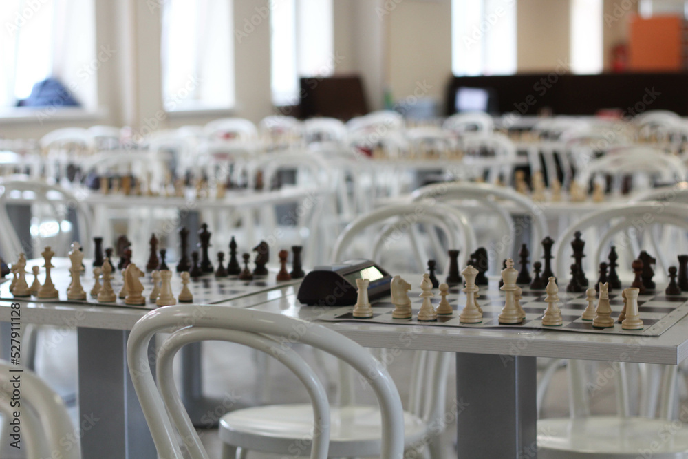 A chess table. Part of interior with white chairs and table. Concept ...