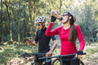 © ADDICTIVE STOCK - Bicyclists on bikes with bottle of water and smartphone