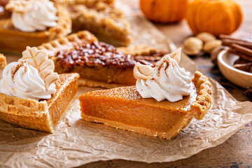 Wall Mural - Variety of Thanksgiving pie slices on parchment paper