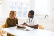 © Cavan Images - Doctor discussing with female patient over ipad record at clinic