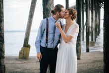 Newlyweds Kissing Together On Beach In The Redwoods, California,