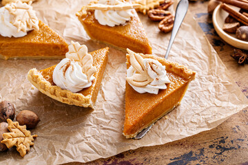 Wall Mural - Festive pumpkin pie slices decorated with whipped cream