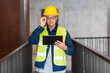© Syda Productions - architecture, construction business and building concept - happy smiling male architect in helmet and safety west with tablet pc computer at office