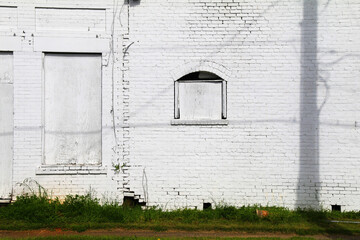 Wall Mural - white painted brick wall building alley factory warehouse boarded windows abandoned shut closed empty city street facade