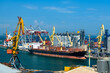 © soleg - industrial seaport infrastructure, sea, cranes and dry cargo ship, grain silo, bulk carrier vessel and grain storage elevators, concept of maritime cargo transportation