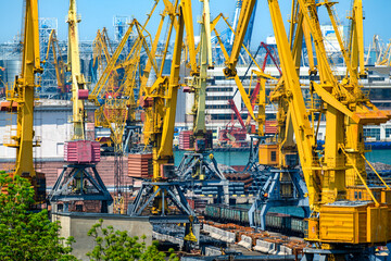 Wall Mural - industrial seaport infrastructure, sea, cranes, buildings and ships, concept of maritime cargo transportation