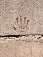 Handprint With Smiley Face In Concrete