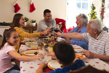 Multi generation caucasian family sitting at table for dinner together