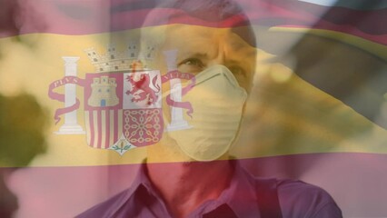 Poster - Animation of flag of spain waving over caucasian man wearing face mask in city street