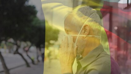 Poster - Animation of flag of belgium waving over caucasian man wearing face mask in city street