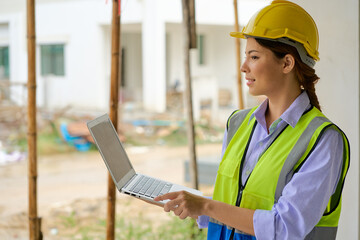 Wall Mural - Female Engineer use laptop for check plan on construction site