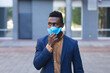 © Wavebreak Media - African american man walking and wearing face mask
