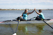 © Wavebreak Media - Two senior caucasian female rowers high fiving each other while rowing the boat on the lake