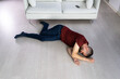 Unconscious Young Man Lying On Floor